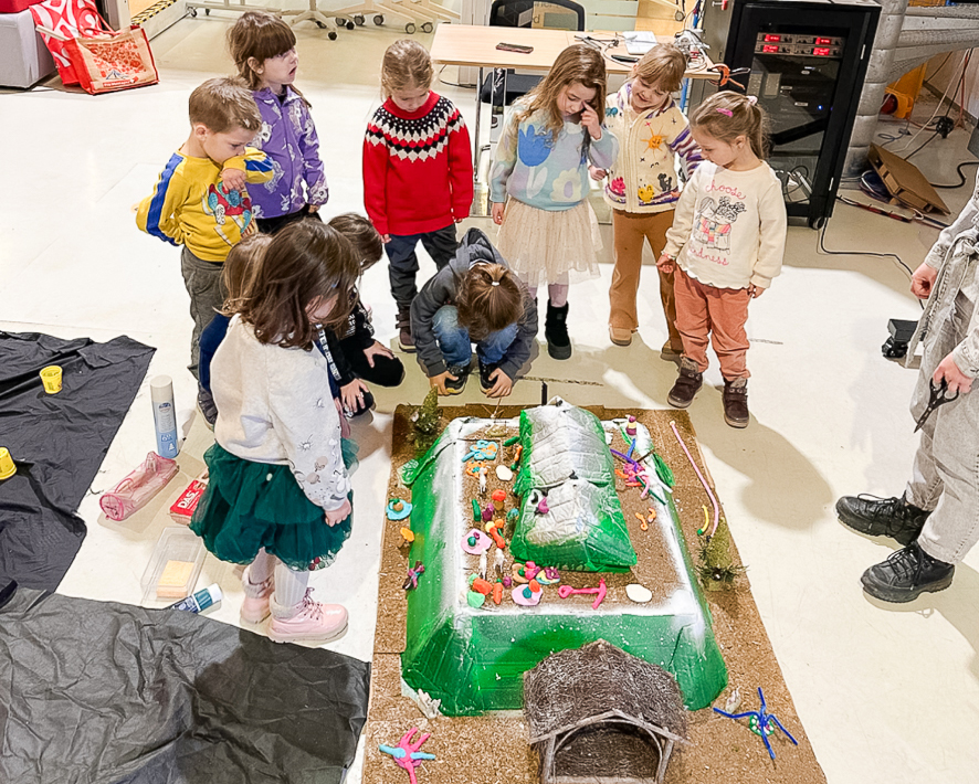 The children placing their creations